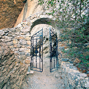 Open iron gate in rock